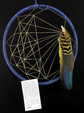 A  blue Siminole  style weave dream catcher by Tom Rael